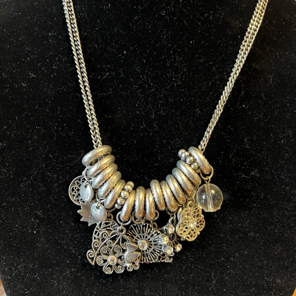 Vintage silver toned double strand metal necklace with many interesting charms